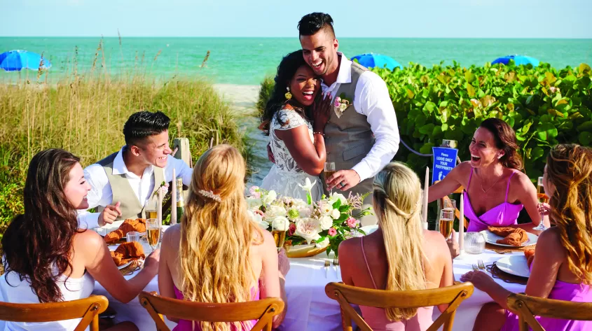 A bridal party enjoy a moment together at the table