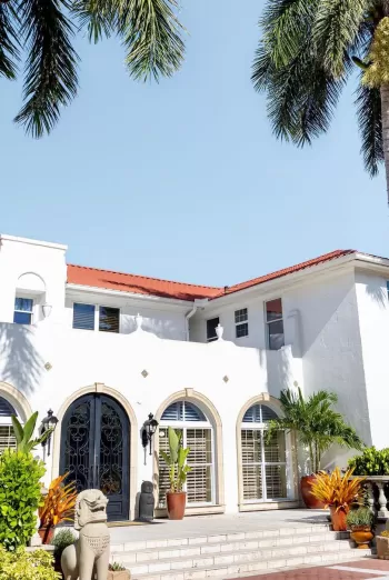 A large white building surrounded by palm trees
